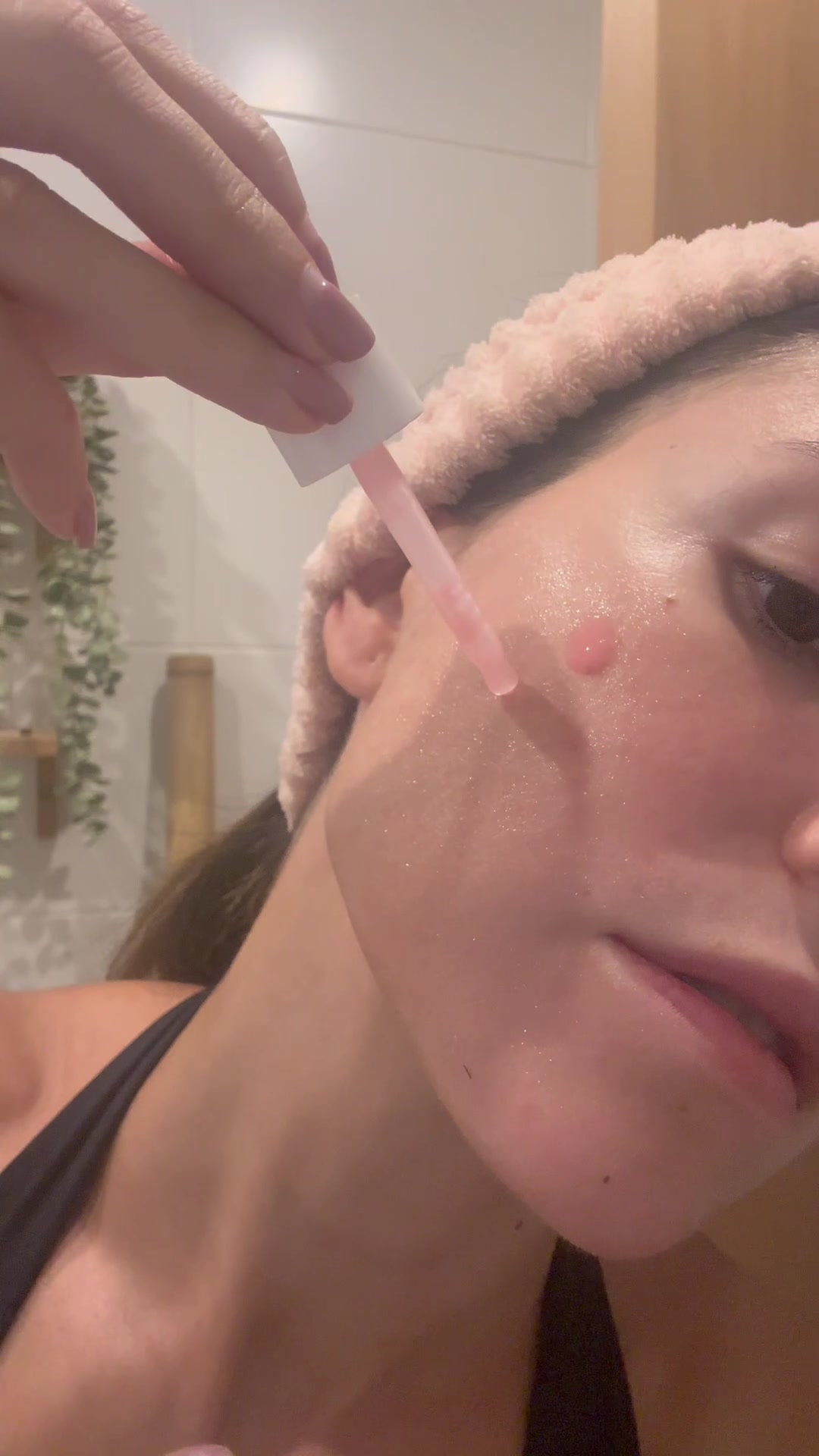 Woman Applies Pink Skincare Serum