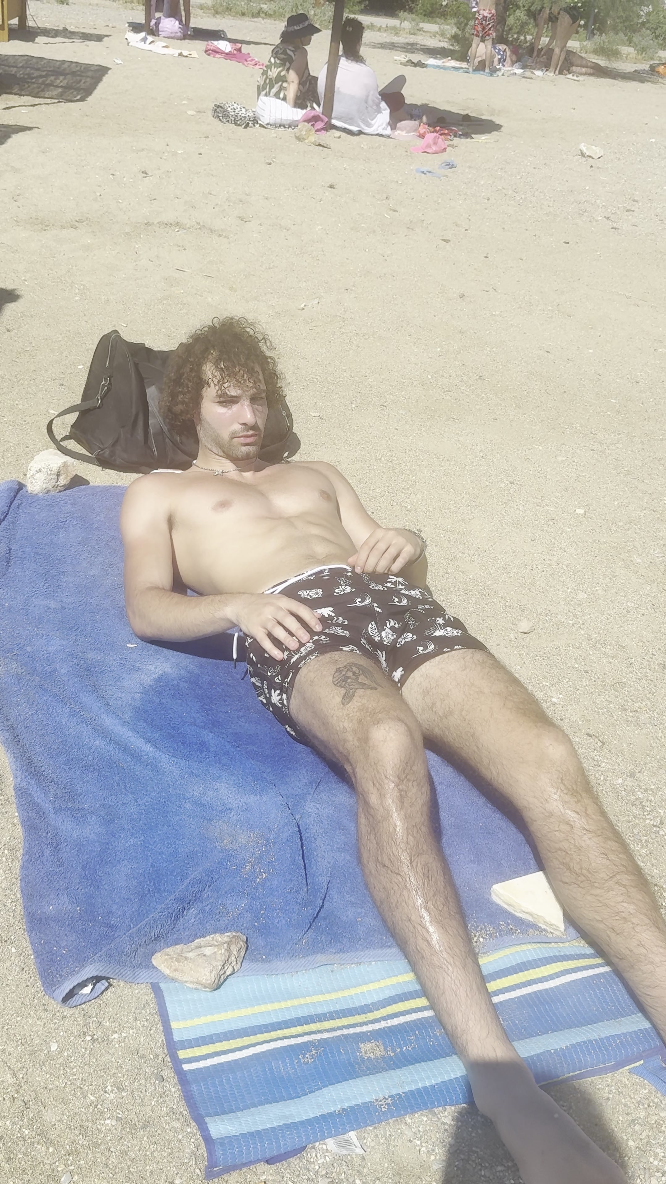 Man Relaxing on Beach Towel