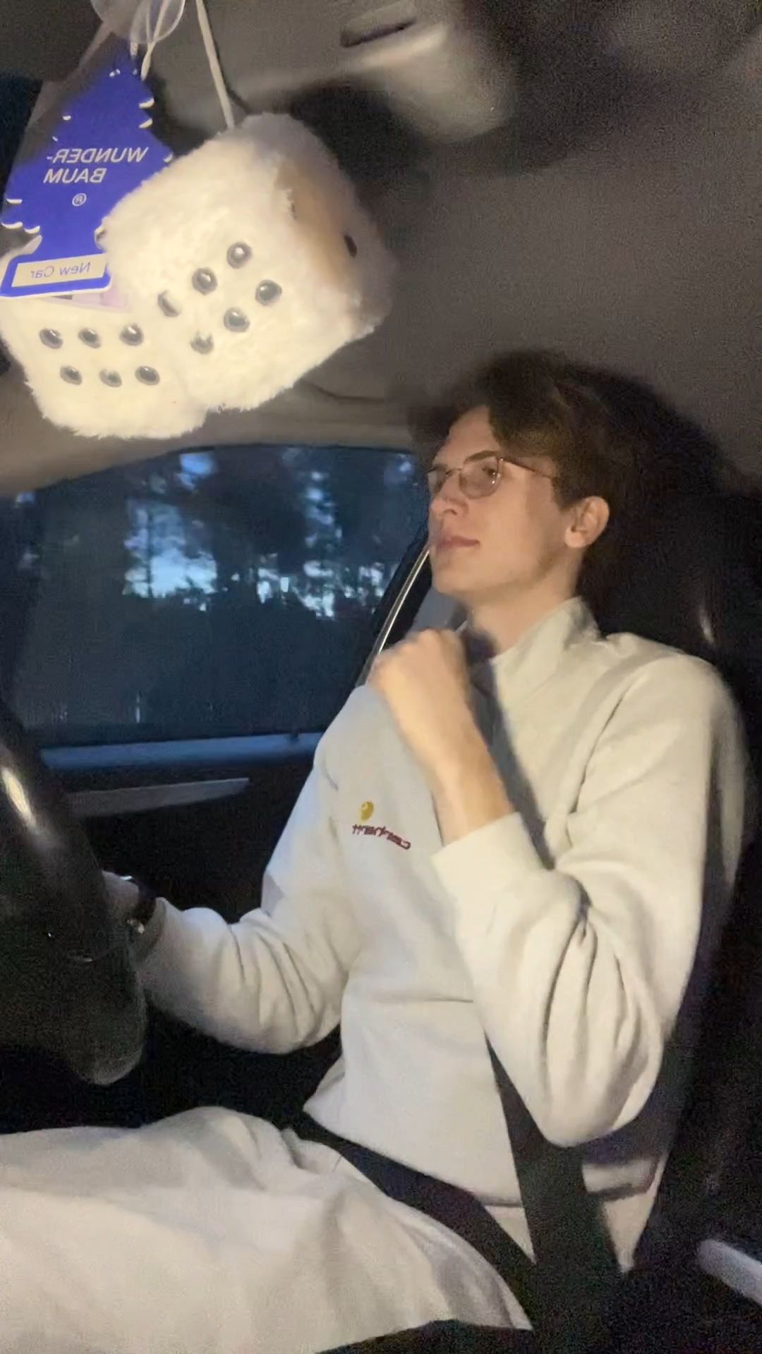 Man happily singing in car