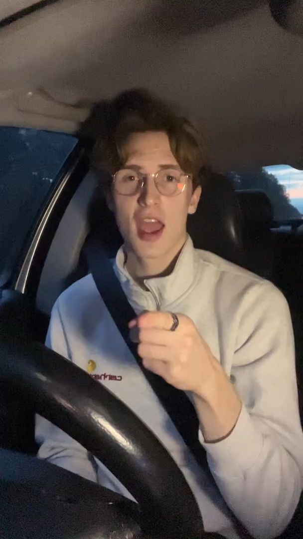 Man Grooving to Music in Car