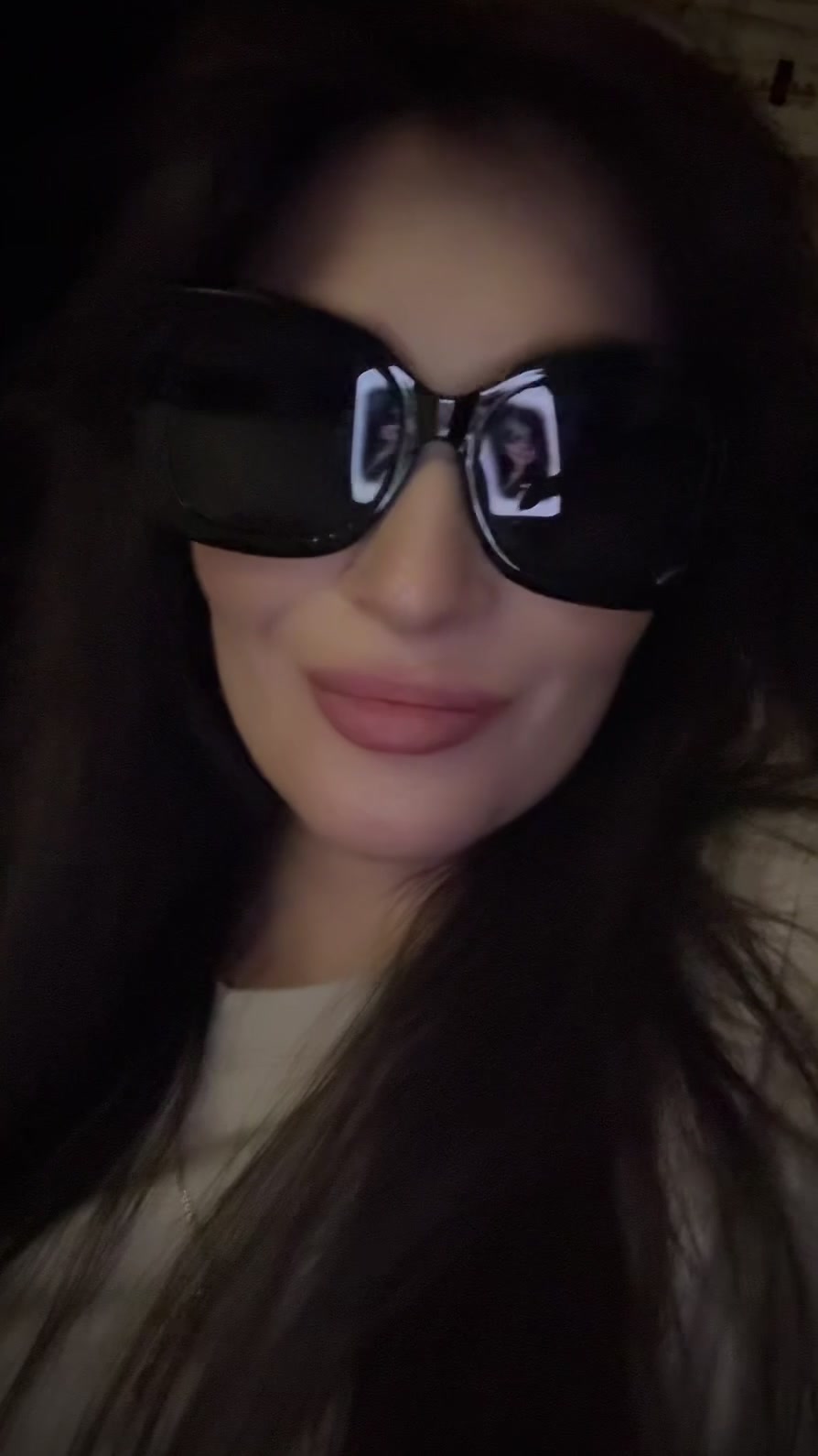 Confident Woman Poses in Sunglasses