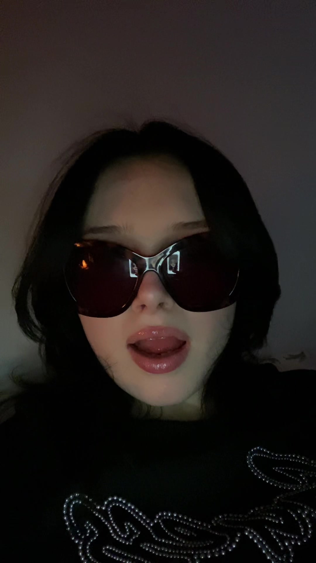 Playful Reaction in Dark Sunglasses