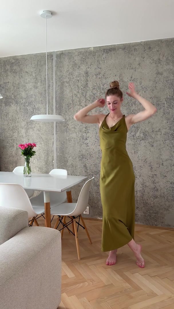 Playful Woman Dances in Green Dress