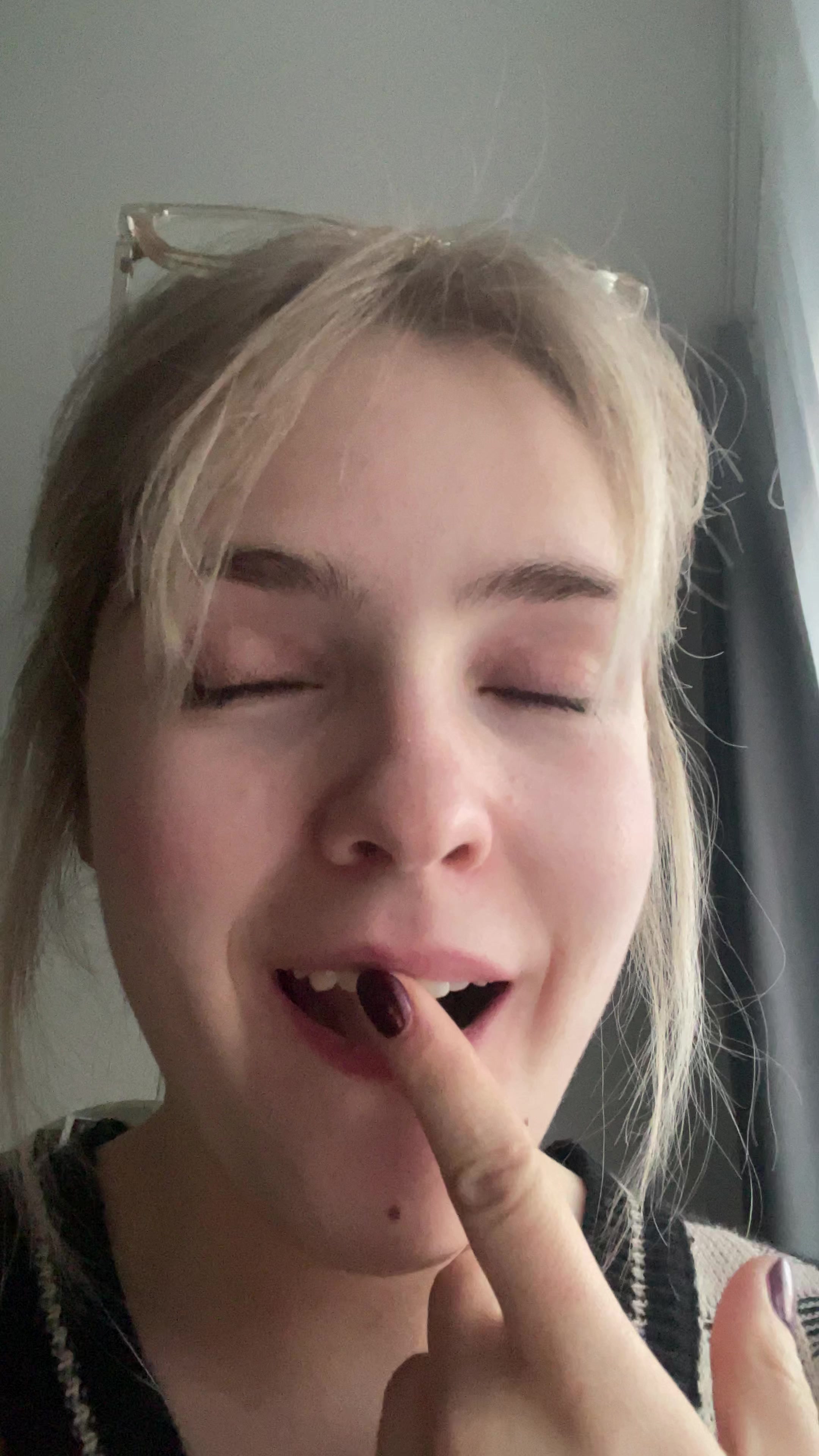 Blonde woman laughing playfully