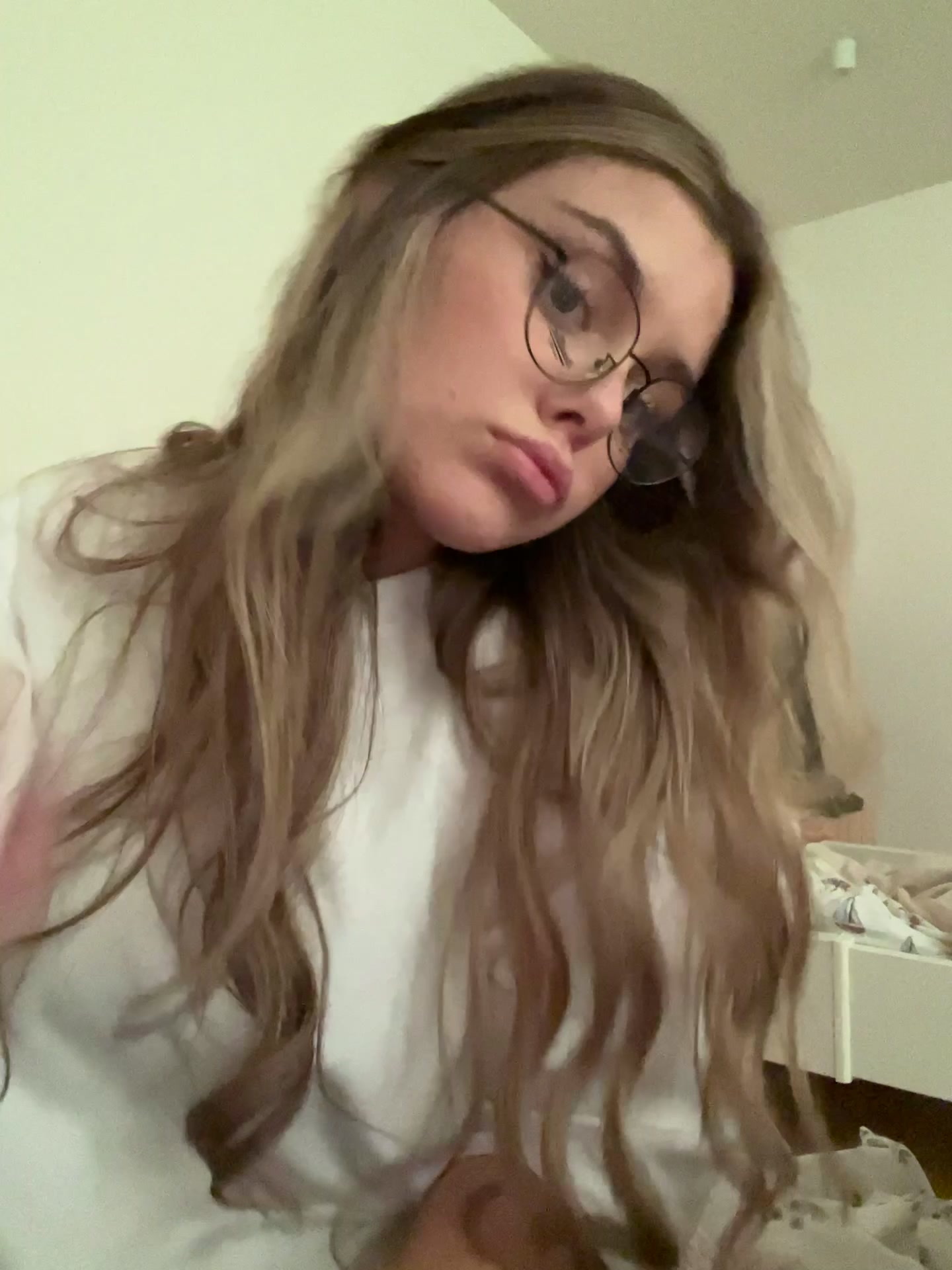 Woman playfully puts on and removes glasses