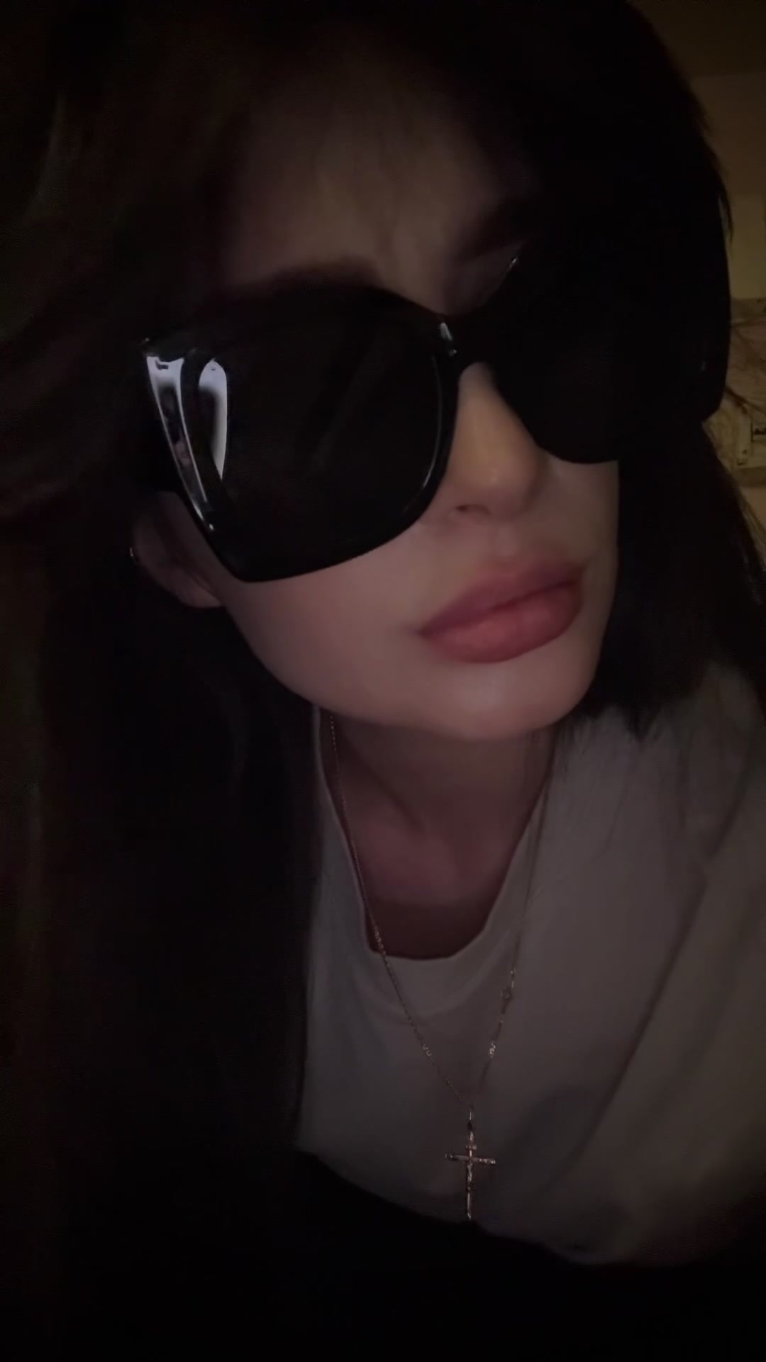 Playful woman with sunglasses sticking tongue