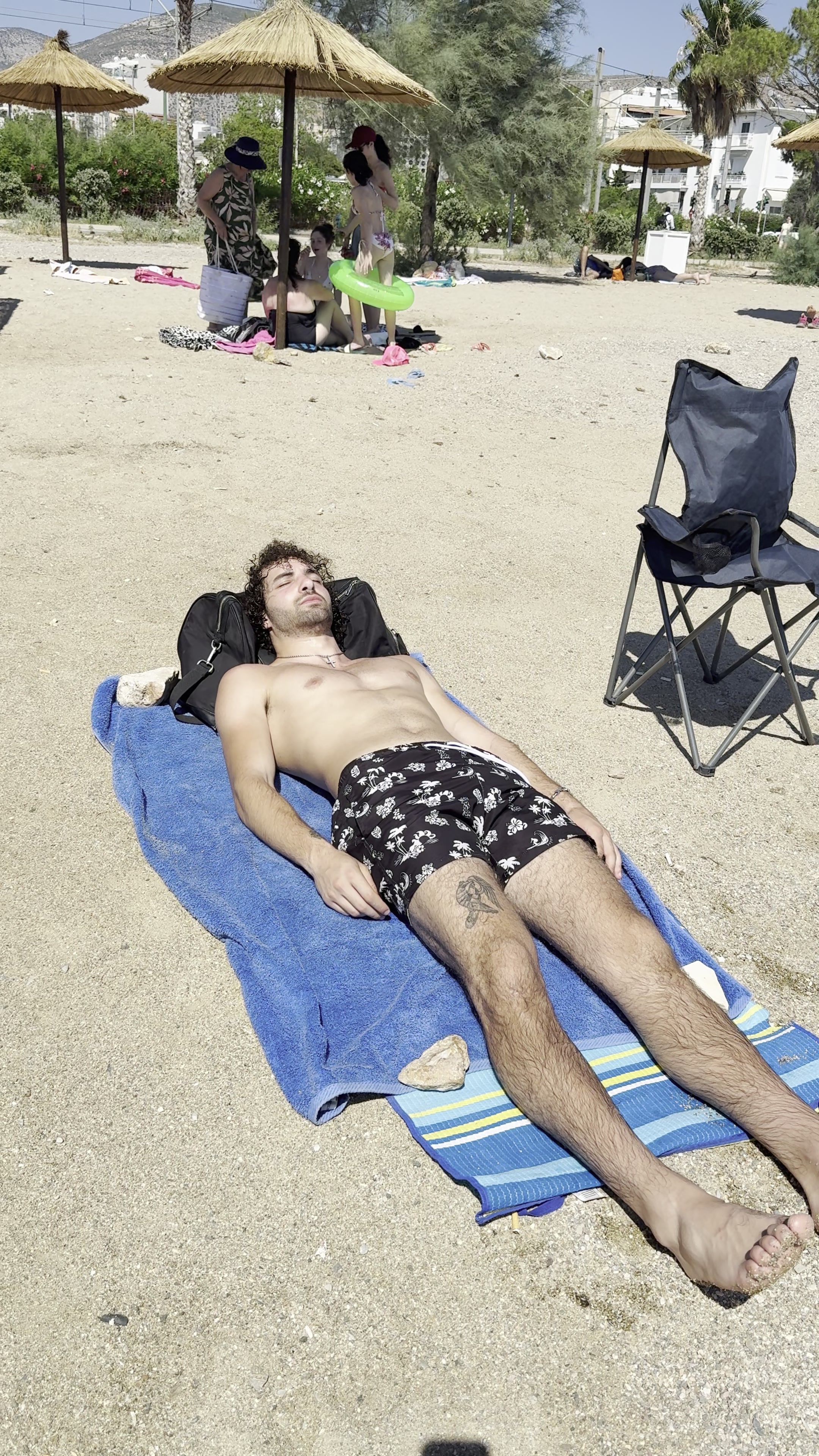 Man sunbathing on beach, called