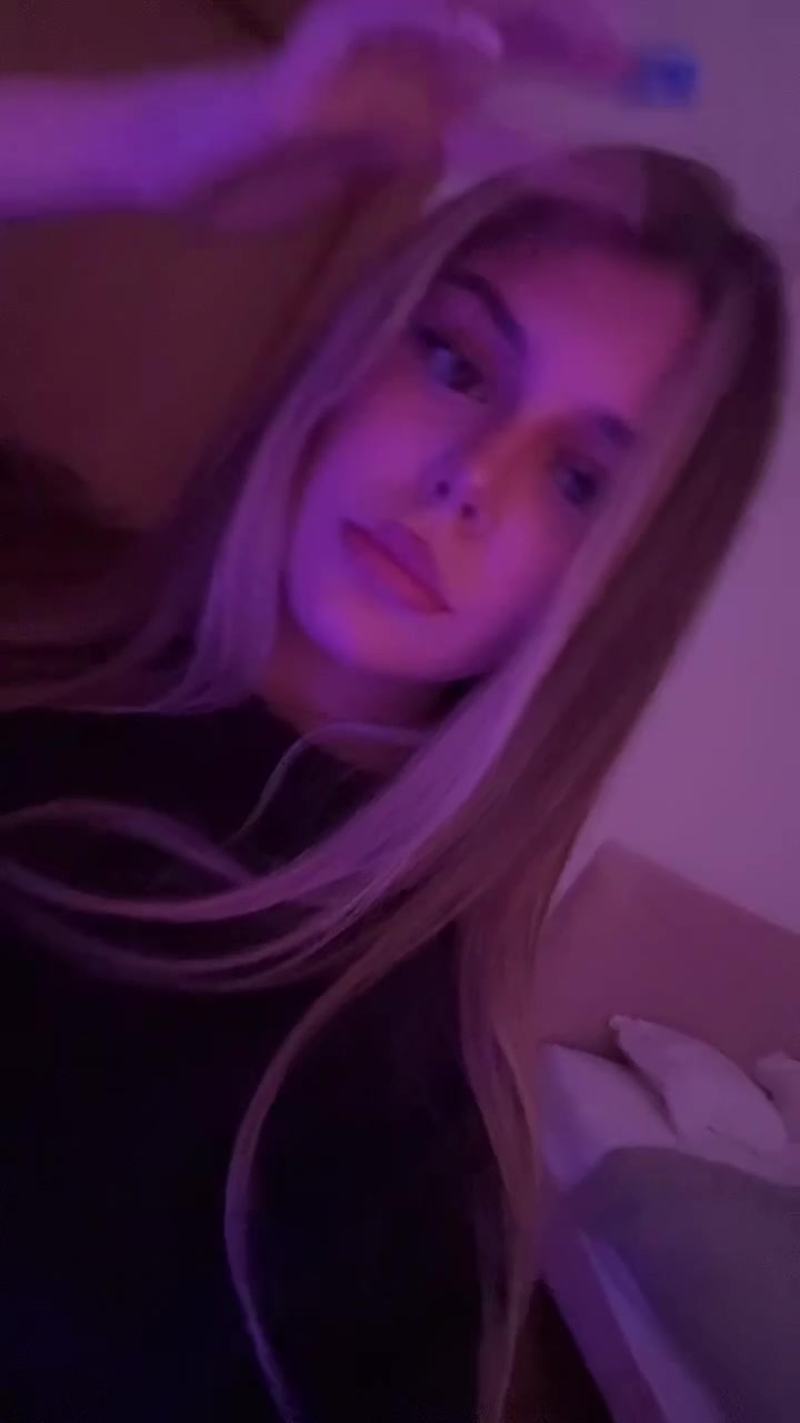 Confident Woman Posing Under Purple Light