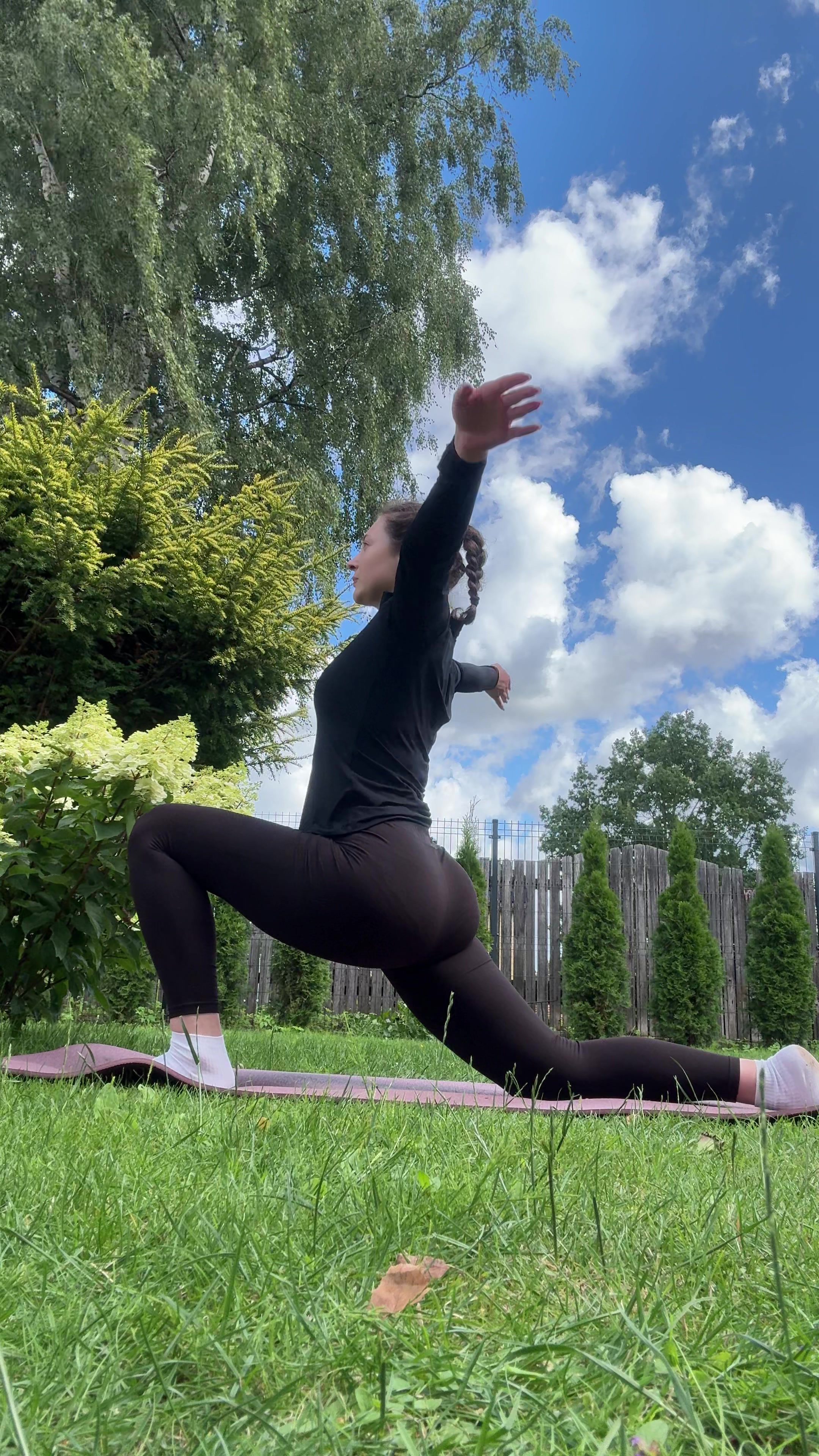 Woman doing yoga stretch outdoors