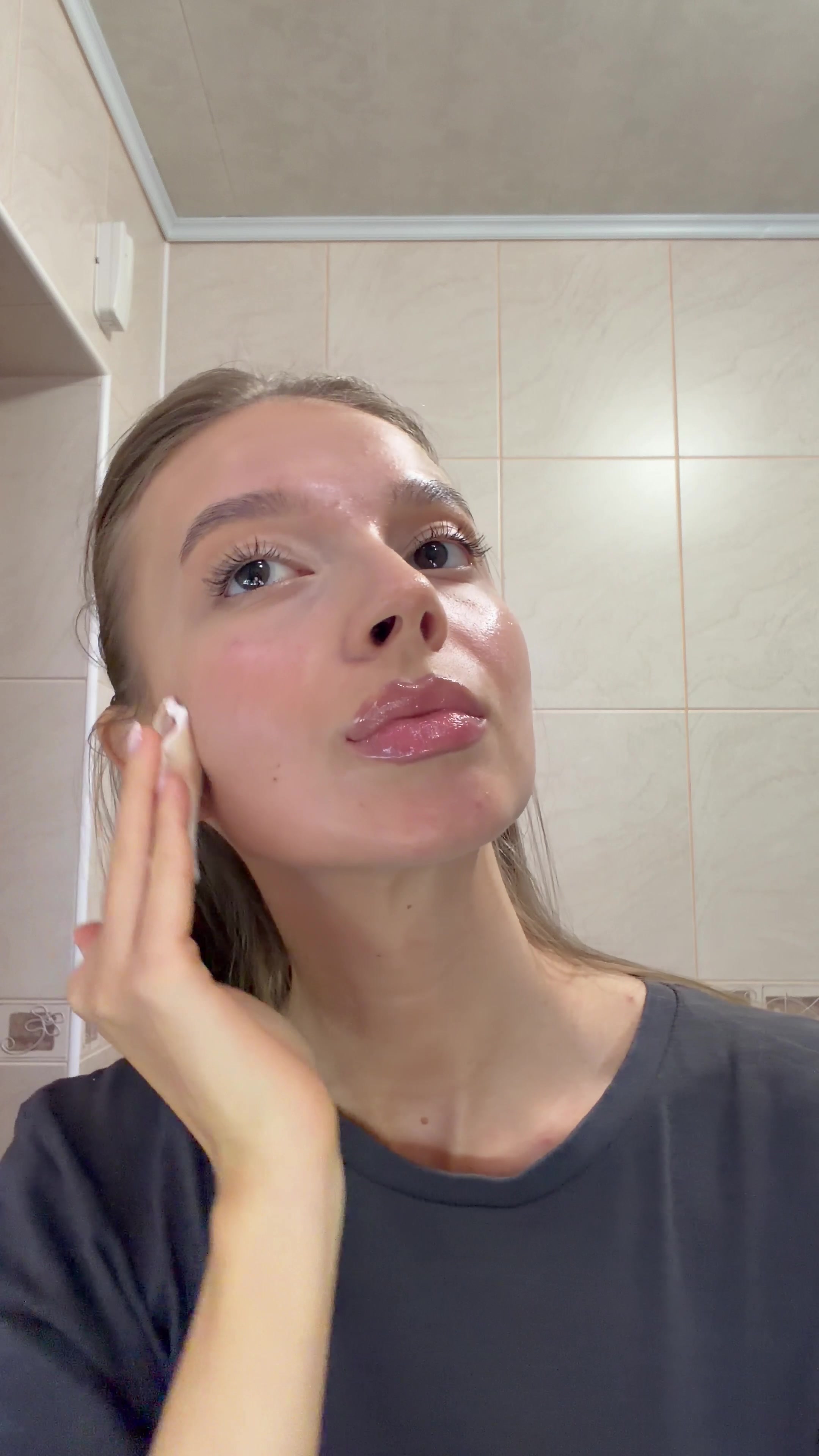 Woman Cleansing Face with Cotton Pad