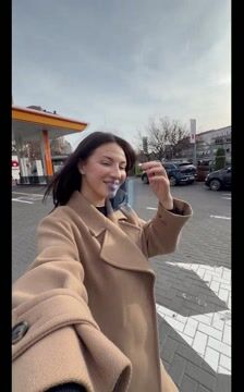 Smiling woman adjusting her hair