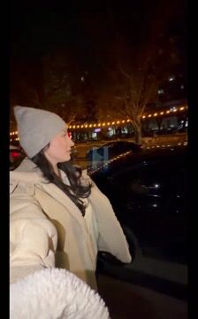 Woman walking at night in city
