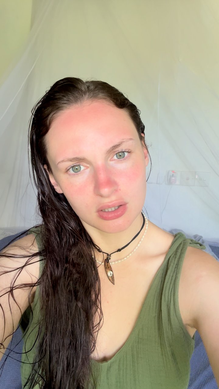 Woman with green eyes reacts curiously
